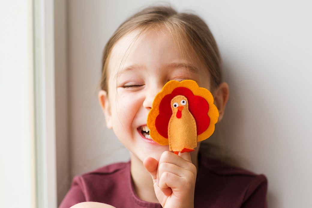 Child with turkey party favor