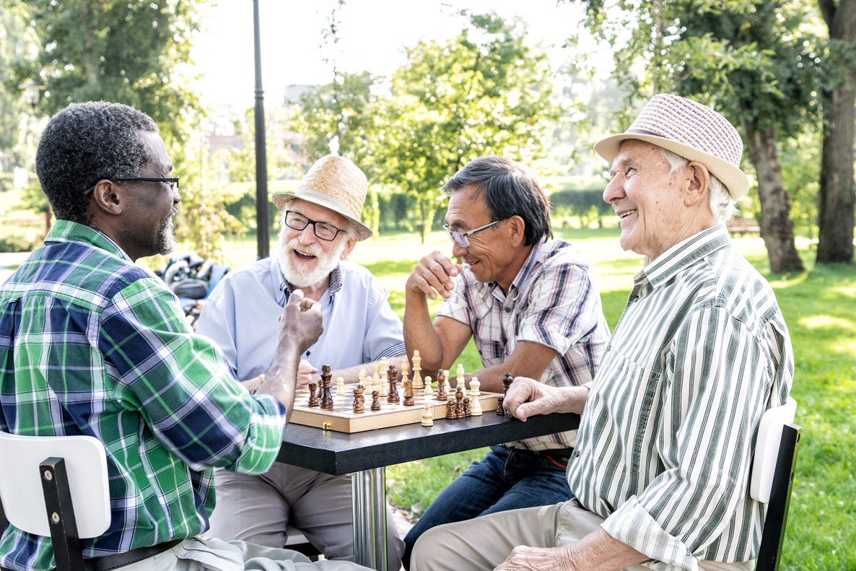 four seniors playing chess